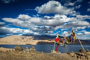 Buddhist prayer flags lungta at Himalayan lake photo