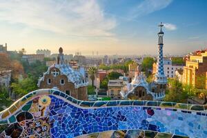 Barcelona city view from Guell Park. Sunrise view of colorful mosaic building in Park Guell photo