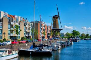 View of the harbour of Delfshaven and the old grain mill De Destilleerketel. Rotterdam, Netherlands photo