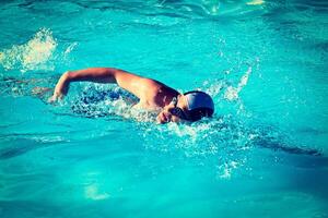 Swimming man swimmer in pool photo