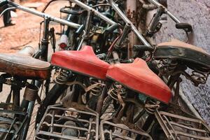 Bicycle saddles close up in Indian street photo