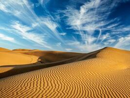 Sand dunes in desert photo