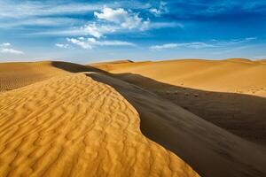 Sand dunes in desert photo