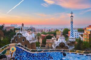 Barcelona city view from Guell Park. Sunrise view of colorful mosaic building in Park Guell photo