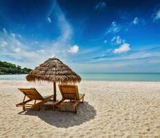 Two beach lounge chairs under tent photo