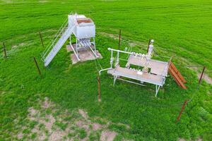 Equipment of an oil well. A tank with methanol near the oil well. Shutoff valves and service equipment photo