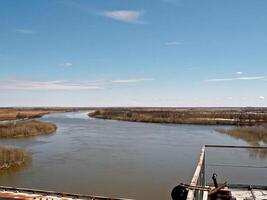 River landscape Early spring. bare trees, melting snow. photo