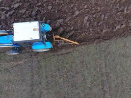 Tractor plowing the garden. Plowing the soil in the garden photo