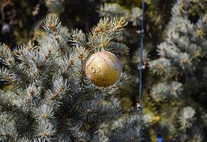 Decorations New Year tree. Tinsel and toys, balls and other decorations on the Christmas Christmas tree standing in the open air. photo