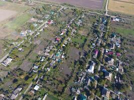 Top view of the village. One can see the roofs of the houses and gardens. Road in the village. Village bird's-eye view photo