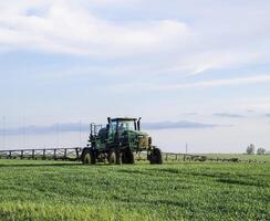 Tractor with a spray device for finely dispersed fertilizer. photo