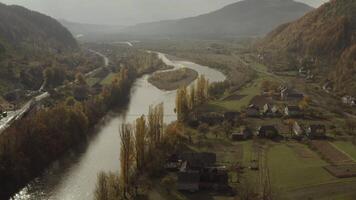 Drone flies over the river in the countryside in the mountains in autumn video