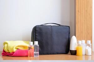travel cosmetics kit with bottles on hotel room table photo