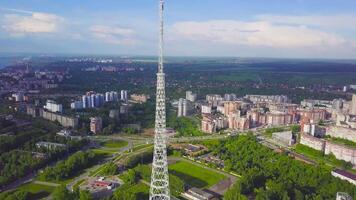 View of communication towers with blue sky, mountain and cityscape background. Video. Top view of the radio tower in the city video