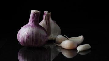 Delicious beautiful garlic on black background. Frame. Concept of a healthy lifestyle video