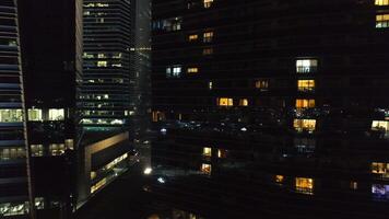 View of a city skyline with skyscrapers in the foreground at night. Shot. Top view of high-rise buildings in center of metropolis at night video