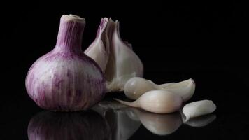 Delicious beautiful garlic on black background. Frame. Concept of a healthy lifestyle video