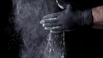 Cotton hands with flour on black background. Frame. Chef clapping hands covered in flour video