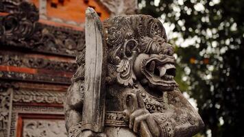 Balinese religious stone carved sculpture, guardian with dagger video