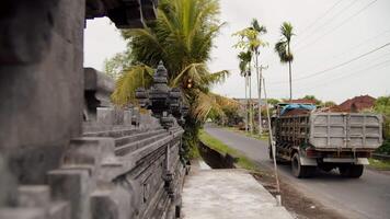 a truck drives down a narrow, empty Balinese street video
