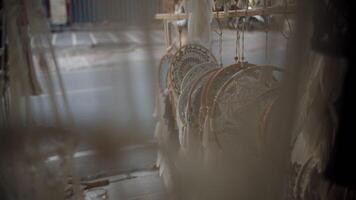 dream catchers hanging in the street market in front of the road. video