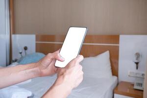 closeup of female hands using smartphone, white blank screen for mockup photo