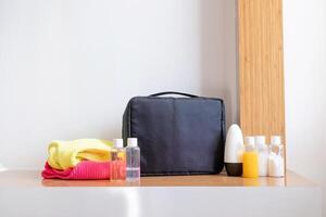 travel cosmetics kit with bottles on hotel room table photo