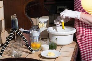 woman cooking spinach muffin step by step,adding vanillin to the dough photo