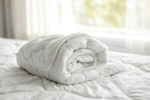 AI generated White folded duvet lying on white bed background photo