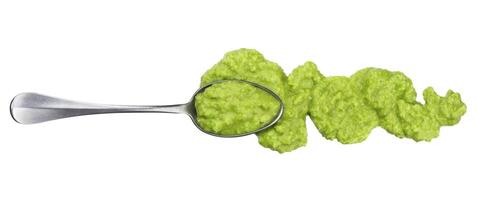 Wasabi isolated. Splashes and spilled wasabi sauce with spoon on white background. Top view photo