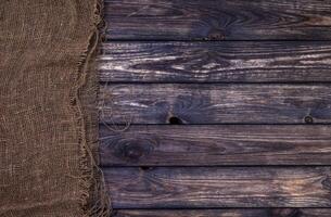 Dark wooden texture with burlap, rustic wood and sack photo