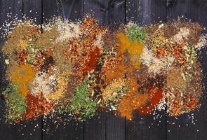 Various spices on wooden background. Top view with copy space photo