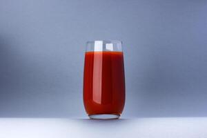 Glass of tomato juice isolated on white background with copy space photo