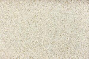 Small crushed rice background or texture photo