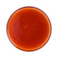 Hot chilli sauce in bowl isolated on white background. Top view photo