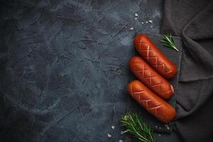 Grilled barbecue sausages with rosemary and spices. Top view. Free space for your text. photo