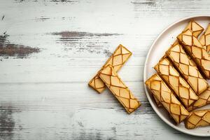 Sfogliatine, an Italian puff pastry with glaze on a plate on white background, top view photo