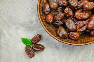 Dried dates in a plate top view photo