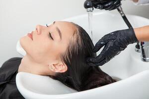 photo of a European girl with long and beautiful brunette hair at the beauty salon. Shiny and healthy hair.