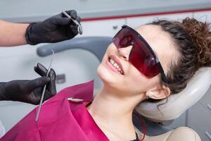 Woman having dental examination in stomatology clinic Treatment of caries, modern medicine. photo