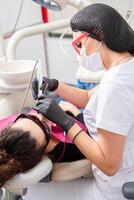 Woman having dental examination in stomatology clinic Treatment of caries, modern medicine. photo