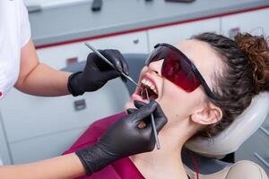 Woman having dental examination in stomatology clinic Treatment of caries, modern medicine. photo
