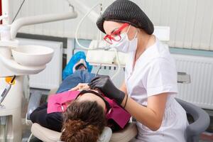 Woman having dental examination in stomatology clinic Treatment of caries, modern medicine. photo