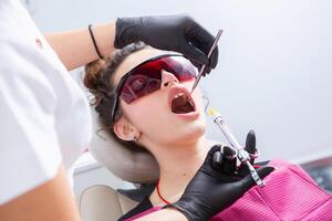 Woman having dental examination in stomatology clinic Treatment of caries, modern medicine. photo