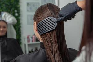 Portrait of a beautiful woman with long brown straight hair in a beauty salon. photo