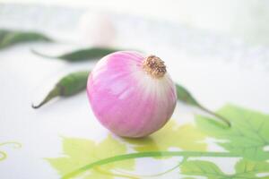 An onion also known as the bulb onion or common onion, is a vegetable that is the most widely cultivated species of the genus Allium. photo