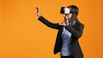 Company worker using virtual reality glasses in studio, enjoying metaverse technology and artificial intelligence on new gadget. Young adult using vr headset for modern visual simulation. photo