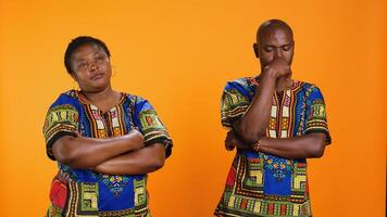 Doubtful ethnic man and woman thinking about solution, rubbing their chin and trying to come up with new ideas. Uncertain people contemplating complex decision, unsure pensive couple. photo