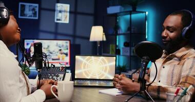 Woman radio show presenter having live conversation with man, recording discussion for audience listening live. Influencer enjoying chat with journalist, broadcasting discussion for fans at home photo