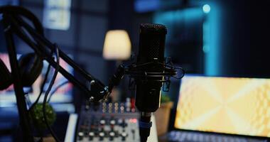 Close up shot of microphone used for podcasts, vlogging and livestreams on vlog channel. Zoom in on professional mic in dimly lit studio used for recording audio during internet show photo